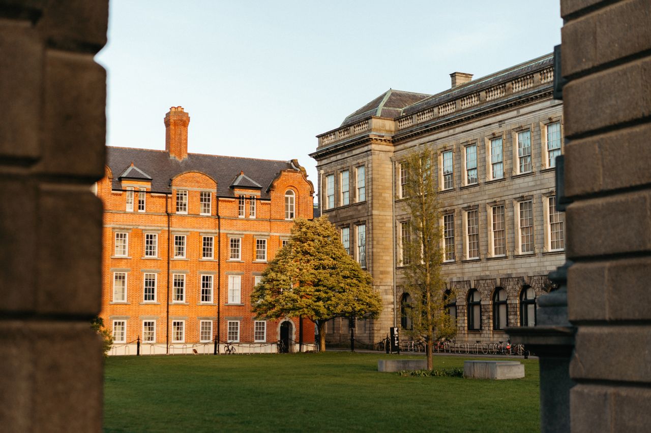 Beautiful historic college buildings in Dublin captured in serene evening light.
